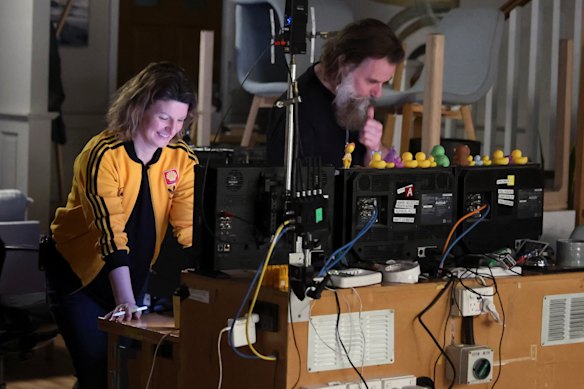 Director Scott Major – who started on the show as a cast member – watches playback of a scene on set.