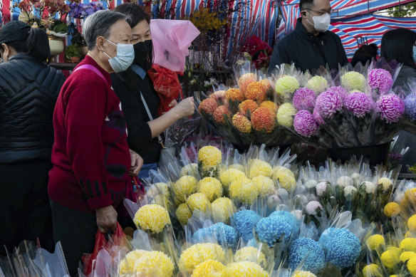 Shoppers look at flower bouquets at a Lunar New Year flower market in the Causeway Bay district in Hong Kong