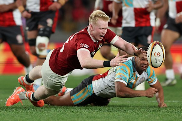 Jamie Osborne of the British & Irish Lions attempts to catch the ball as Kurtley Beale challenges him.