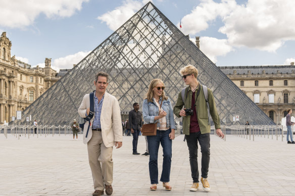 In happier times: Douglas (Tom Hollander), Connie (Saskia Reeves) and Albie (Tom Taylor) do the Louvre in Us.