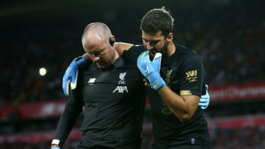 Alisson leaving the pitch following his calf injury last Friday night.