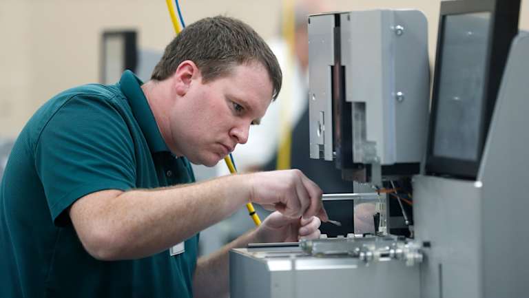 An employee at the Broward County's elections office cleans machines during the recount.