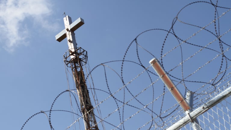 A steel cross rises above the border fence at the Demilitarised Zone seperating North and South Korea.