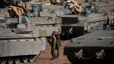 Israeli soldiers prepare their armoured vehicles at a gathering point near the Israel-Gaza Border, on Wednesday.