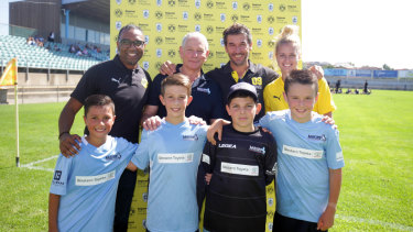 Dortmund regional managing director Suresh Letchmanan (back row, left) and ambassador Karl-Heinz Riedle (back row, third from left) with Marconi representatives. 