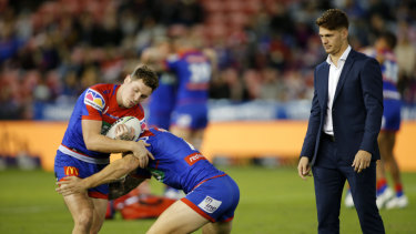 Scratching: Kalyn Ponga watches the Knights warm up before their clash with Brisbane.