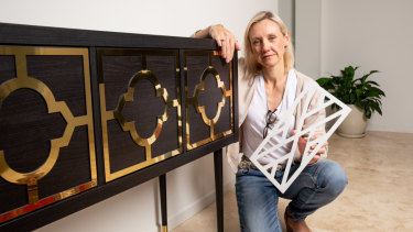 Kylie Hughes with one of the Ikea cabinets she has refurbished. 