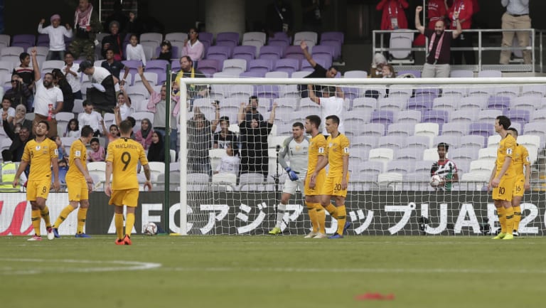 Unbelievable: The dejected Socceroos after Jordan's first-half goal.