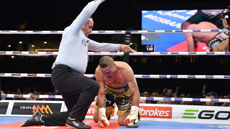 Down and out: Referee Phil Austin waves off the fight with Anthony Mundine unable to find his feet.