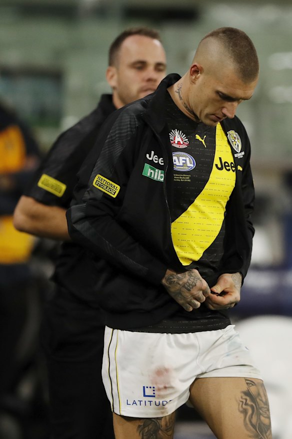 Dustin Martin puts on a jacket after leaving the ground with concussion.