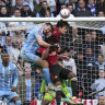 Manchester United’s Harry Maguire beats Coventry City’s Liam James Kitching to the ball.