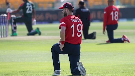 England’s Chris Woakes along with teammates and the Bangladesh side take a knee before their T20 World Cup clash in Abu Dhabi.