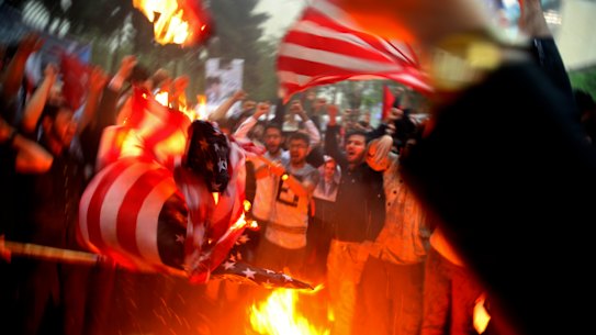 Iranian demonstrators burn representations of the US flag during a protest in front of the former US Embassy after Donald Trump pulled the US out of the nuclear deal.