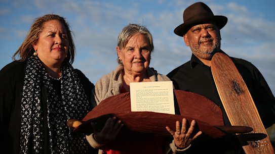 Megan Davis, Pat Anderson and Noel Pearson with a piti holding the Uluru Statement from the Heart in May 2017.