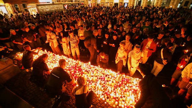 People light candles on the main square in Graz’s city centre after the deadly school shooting.