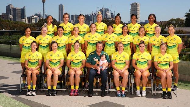 The Australian women's sevens team, with Emilee Cherry's daughter Alice sitting on the coach's knee.