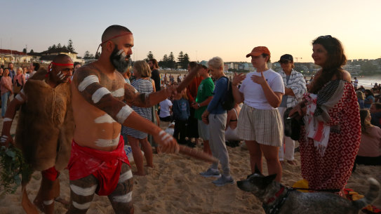 First Nations Elder Dean Kelly (left) and Yuin Gurungi dancers lead a Dawn Reflection and Smoking Ceremony at Bondi Beach.
