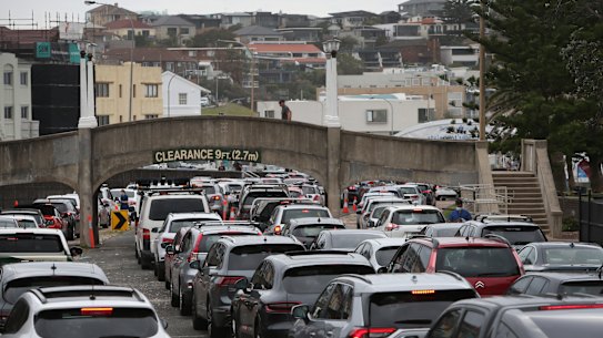 People queue at the St Vincent’s Bondi Beach COVID-19 drive-through testing clinic on Friday.