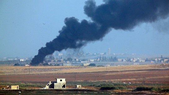 Smoke billows from a fire inside Syria during a bombardment by Turkish forces.
