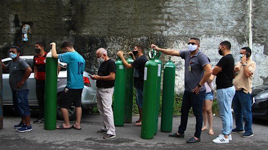 Family members of patients hospitalised with COVID-19 line up with empty oxygen tanks in an attempt to refill them, in Manaus, Amazonas state, Brazil.