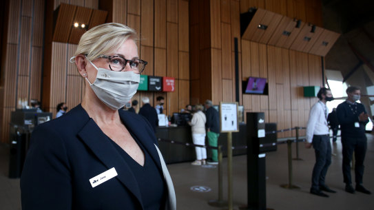  A staff member wears a mask as she greets guests arriving for the Don Burrows: A Celebration of Life Through Jazz.