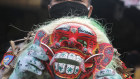 A police officer holding a Balinese traditional mask, called celuluk, portraying the coronavirus during a campaign to get people to wear masks. 