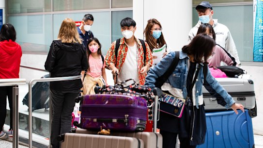 Travellers arriving at Sydney International Airport on Sundy. All international arrivals have to self isolate for 48 hours due to the Omicron variant.