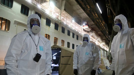 In Wollongong, NSW Police officers prepare to board the Ruby Princess cruise ship to seize evidence in what is now a criminal investigation. 