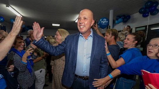 Home Affairs Minister Peter Dutton celebrating his return to the seat of Dickson while in Strathpine on election night.