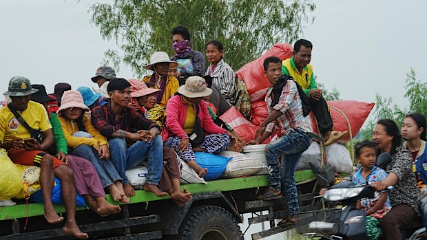 Cambodians sit on a cart of a tractor as they take refuge in Oddar Meanchey province, Cambodia on Saturday.