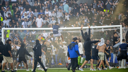 Melbourne Victory fans invade the pitch during the A-League Men’s soccer match between Melbourne City and the Melbourne Victory at AAMI Park in Melbourne, 
