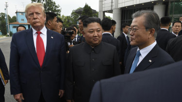 US President Donald Trump, left, North Korean leader Kim Jong-un, centre, and South Korean President Moon Jae-in, right, at the Demilitarised Zone in June.