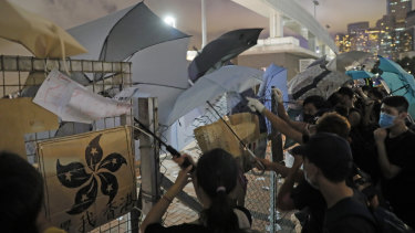 Anti-extradition bill protesters put up umbrellas to defend themselves from riot police at the Central Waterfront in Hong Kong.