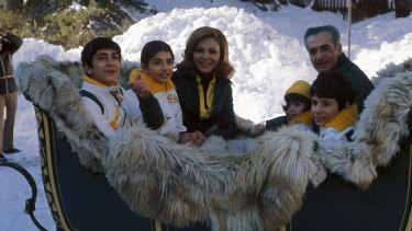 Farah Pahlavi with the Shah and their children in Switzerland, 1975.