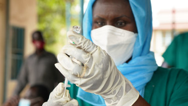 A healthcare worker prepares to administer an AstraZeneca dose from the COVAX supply in Juba, South Sudan.