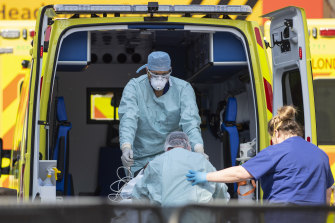 A patient is taken from an ambulance at St Thomas' Hospital on April 10 in London.
