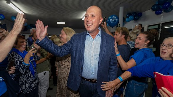 Home Affairs Minister Peter Dutton celebrating his return to the seat of Dickson while in Strathpine on election night.