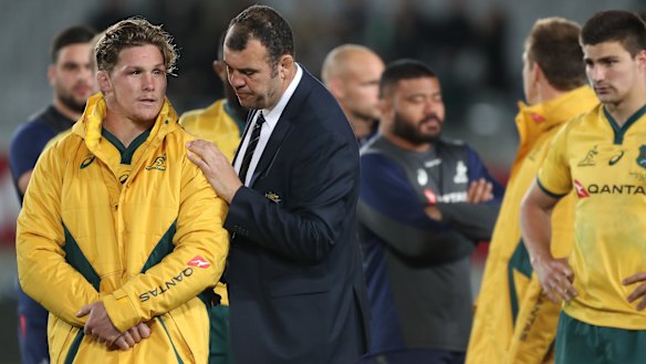 Taking stock: Michael Hooper is comforted by coach Michael Cheika after Bledisloe II in in Auckland.