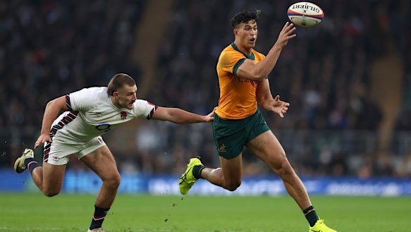 Joseph Sua’ali’i taps the ball to a support player during the Wallabies’ win against England.