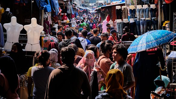 Indonesians crowd the Tanah Abang textile market to buy new clothing, a tradition for upcoming the Eid al Fitr holiday in Jakarta, Indonesia.