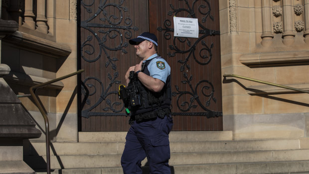 Police outside St Mary's Cathedral in the CBD on Friday.