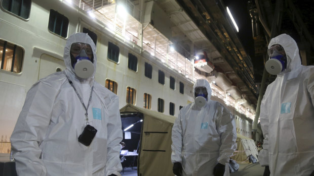 In Wollongong, NSW Police officers prepare to board the Ruby Princess cruise ship to seize evidence in what is now a criminal investigation. 