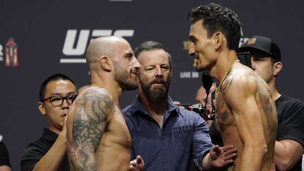 Alex Volkanovski and Max Holloway square off at the weigh-in before they fight on Sunday.
