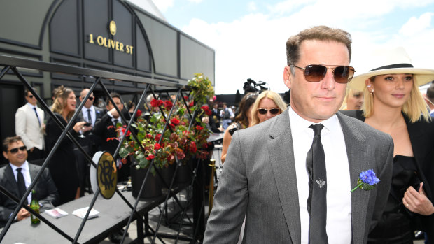 A man under intense scrutiny - Karl Stefanovic braves the crowds at the Spring Racing Carnival in 2017 with his then girlfriend, Jasmine Yarbrough.
