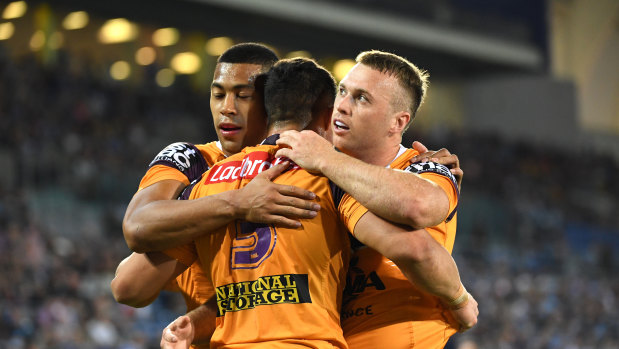 The Broncos celebrate another try during their stroll against the Gold Coast.