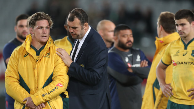 Down and out: Michael Cheika consoles Michael Hooper after Australia surrendered the Bledisloe Cup for the 16th straight year.
