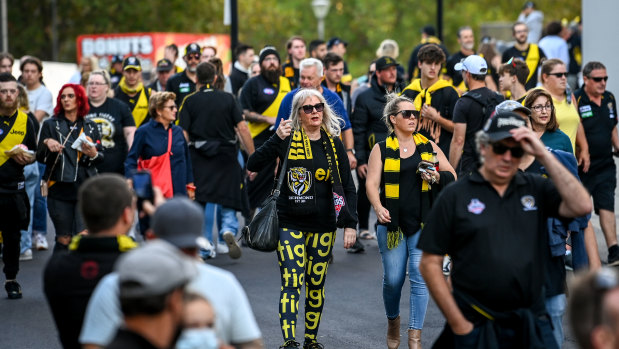 Fans enter the MCG to watch live AFL for the first time in more than 500 days.