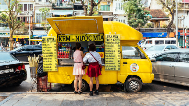 A yellow food truck in Hanoi. Emily Clements' memoir begins with her adrift in the Vietnamese city.