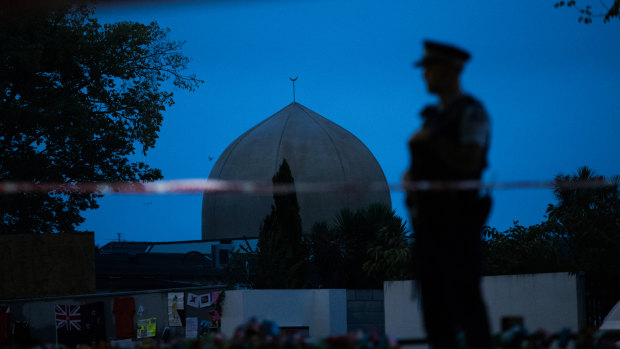 A policeman stands guard at the Al Noor Mosque ahead of a national call to prayer.