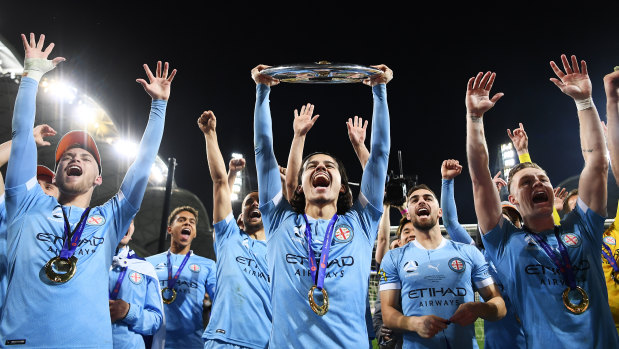 Stefan Colakovski of Melbourne City celebrates victory with teammates and holds aloft the A-League trophy after the grand final between Melbourne City and Sydney FC at AAMI Park.